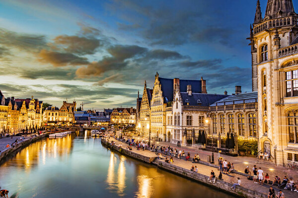 GHENT, BELGIUM - AUG 24, 2022: Architecture of the historic city center of Ghent in the Flemish Region of Belgium, after sunset