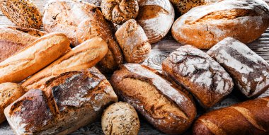 Composition with assorted bakery products on wooden table.