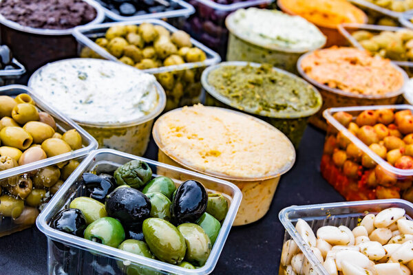 Olives in plastic boxes put up for sale in the store.