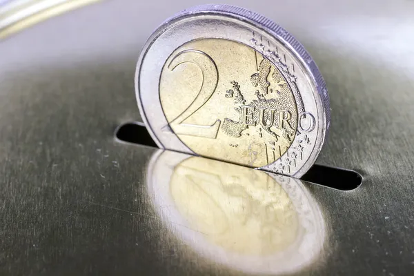 Saving two euros in a piggy bank — Stock Photo, Image