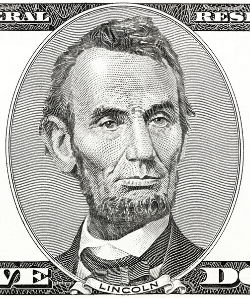 president Abraham Lincoln as he looks on five dollar bill obverse