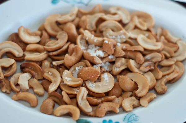Cashew nuts with salt on dish — Stock Photo, Image