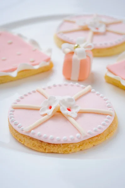 Many pink cookies on a white plate — Stock Photo, Image