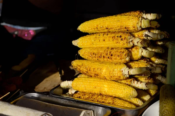 Grilled corn. Street food festival. Close up of appetizing grilled sweet corn on the bbq