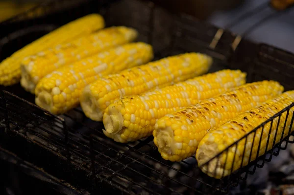 Grilled corn. Street food festival. Close up of appetizing grilled sweet corn on the bbq