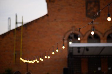 Sokaktaki ahşap bir standın üzerindeki lamba çelenkleri. Düğün ziyafeti..