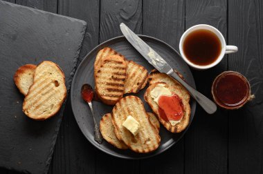 Continental Breakfast meal served with coffee, toast, jam and butter. Delicious coffee table.