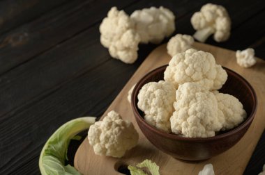 Ahşap zemin üzerinde çiğ, taze organik karnabahar. Sağlıklı beslenme, düşük karbonhidrat diyeti