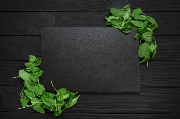 Kitchen table with stone cutting board, decorated with herbs.