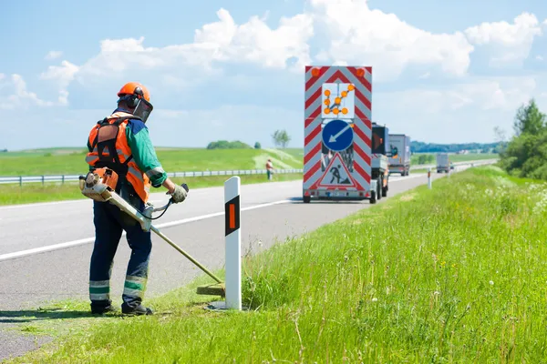 Landscapers δρόμο κοπή χλόης χρησιμοποιώντας Στριγκάκι μηχανές ξακρίσματος χλοοτάπητα — Φωτογραφία Αρχείου