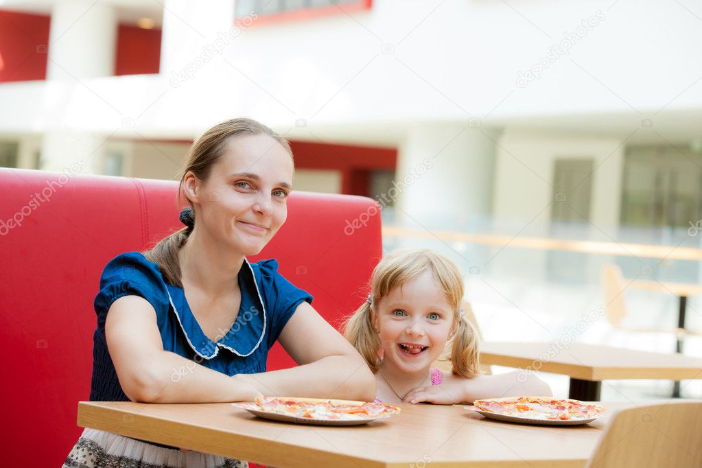 Mom and daughter relaxing in cafe