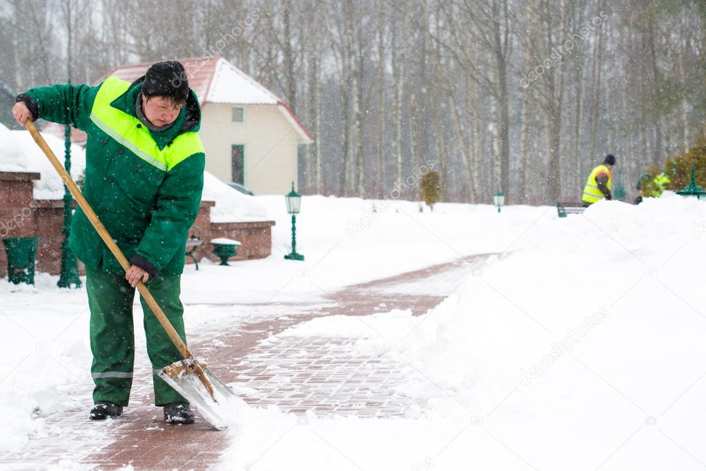Worker shoveling snow