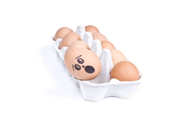 Frightened egg falling from container — Stock Photo, Image