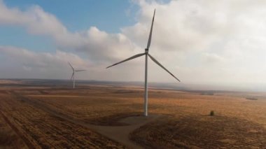 Wind turbines turns on the yelow field