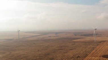 Wind turbines on field, soft citematic light