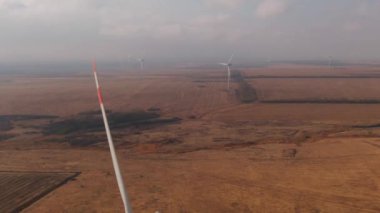 Wind farm, wind turbine propeller rotating on the foreground
