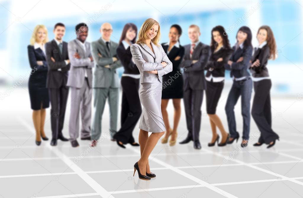 Young business woman and her team isolated over office background