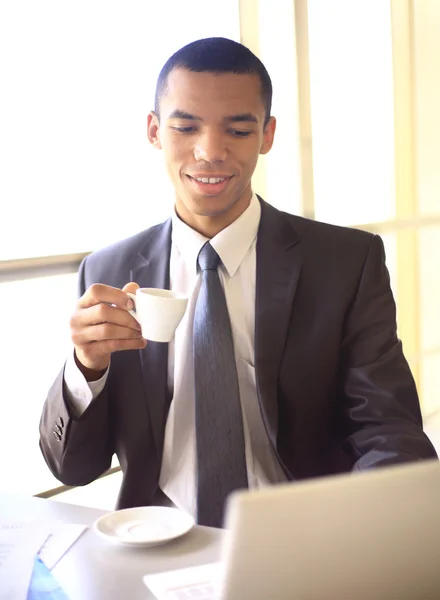 Young african businessman having coffee break — Stock Photo, Image