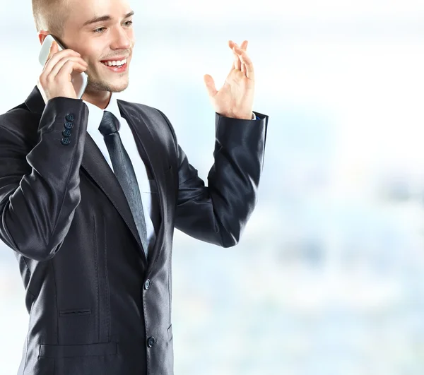 Charming businessman phoning in his office Royalty Free Stock Images