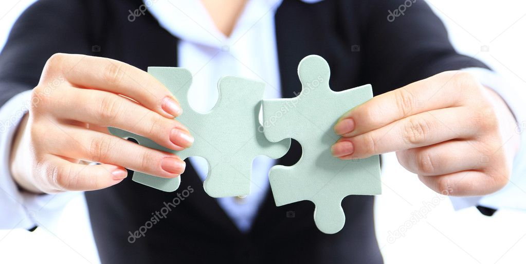 Business woman showing two jigsaw puzzle pieces . Concept for business strength and success