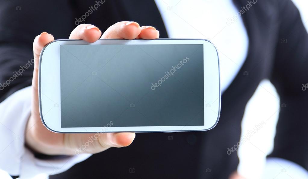 Close up of a happy woman showing her new phone on white background