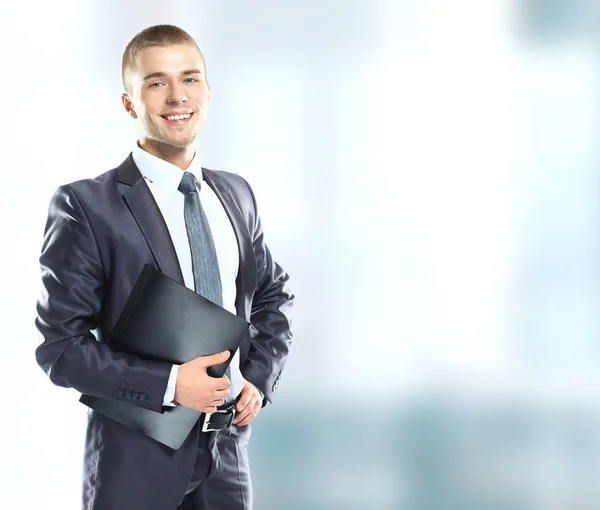 Portrait of happy smiling young businessman with folder. — Stock Photo, Image