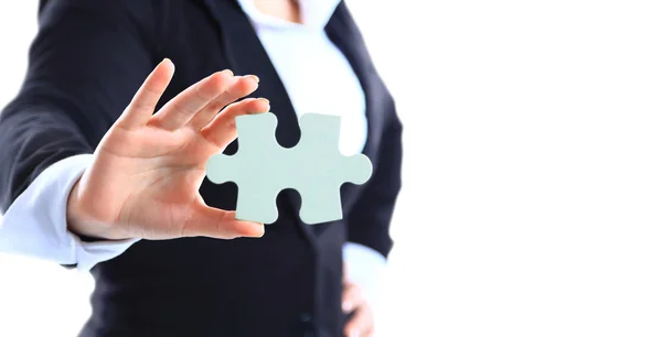 Business woman holding a piece of puzzle — Stock Photo, Image