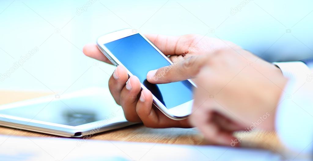 Close up of a man using mobile smart phone