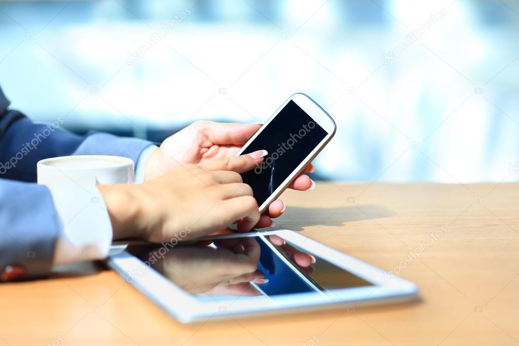 Businessman using digital tablet computer with modern mobile phone. New technologies for success workflow concept.