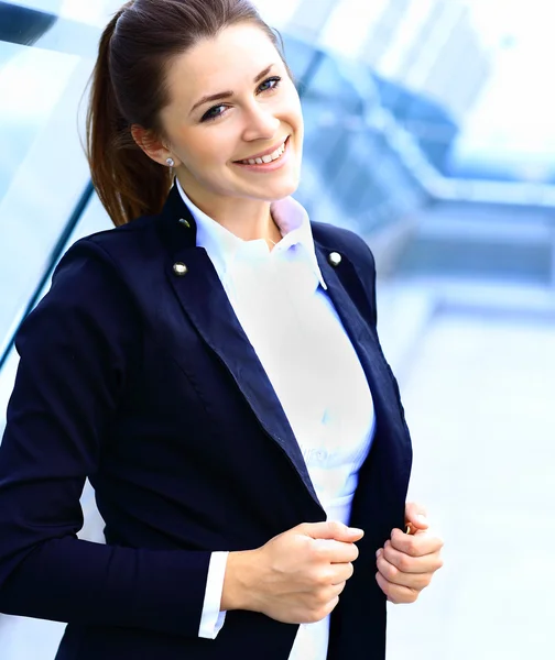 Portrait of young business woman on building background — Stock Photo, Image