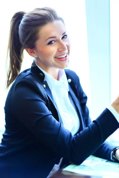 Young beauty smiling woman sitting in a cafe Stock Picture