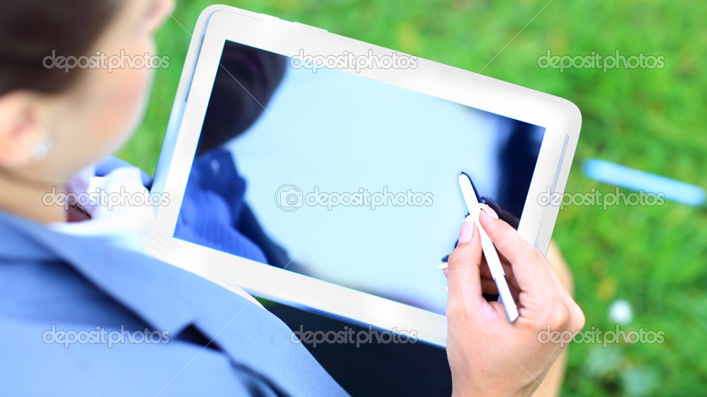 Woman's hand touching screen on modern digital tablet pc. Close-up image