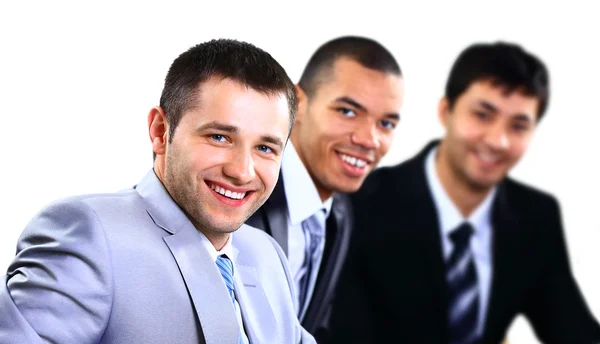 Glad smart affärsman med lagkamrater i bakgrunden — Stockfoto