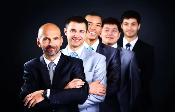 Young attractive business people with leader — Stock Photo, Image