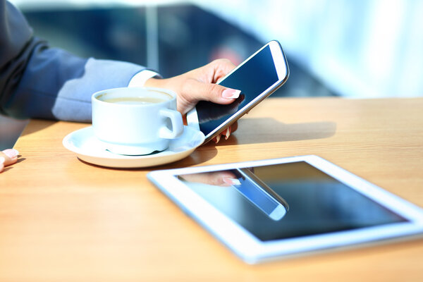 Modern workplace with digital tablet computer and mobile phone, cup of tea