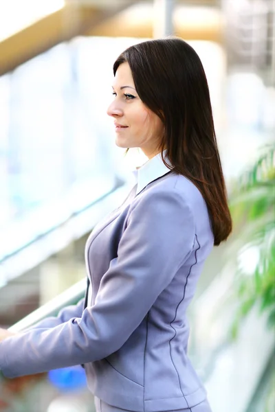 Young pretty business woman in the bright modern office indoors — Stock Photo, Image