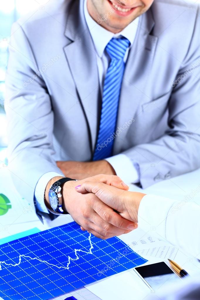 Businessman shaking hands to seal a deal with his partner