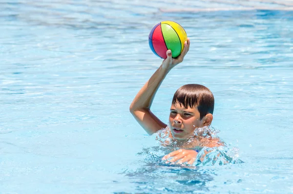 Chlapec s míčem v bazénu — Stock fotografie