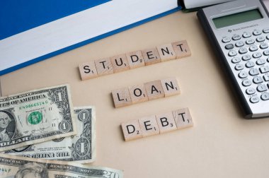 Calgary, Alberta - April 21, 2022: Sutdent debt concept with american dollars as a background.