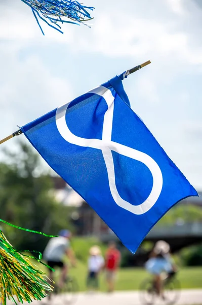 Metis flag hanging in the wind on nice summer day.