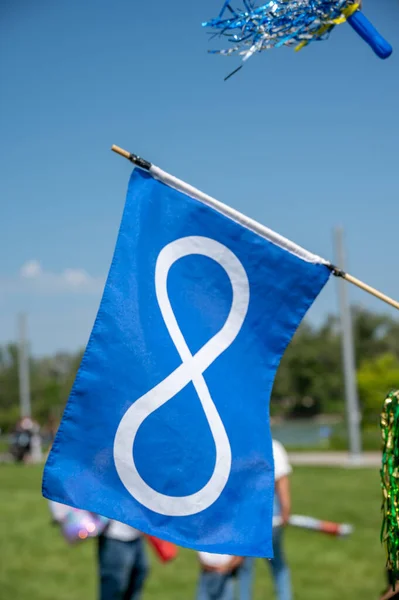 Metis flag hanging in the wind on nice summer day.