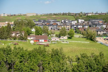 Views of new suburban construction encroaching on old farm acreages.