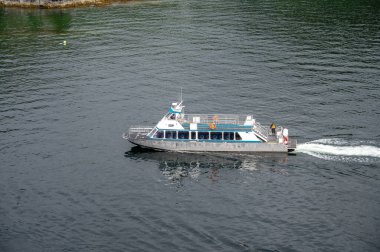 Sitka, Alaska - July 26, 2022 - View of Adventure Sitka's  Kalinin Express cruise boat picking up kayakers.
