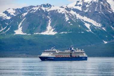 Hubbard Glacier, Alaska - July 28. 2022: The Celebrity Millenium cruise ship sailing away from Hubbard Glacier into the Pacific Ocean in Alaska.