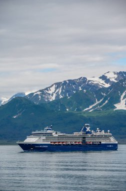 Hubbard Glacier, Alaska - July 28. 2022: The Celebrity Millenium cruise ship sailing away from Hubbard Glacier into the Pacific Ocean in Alaska.