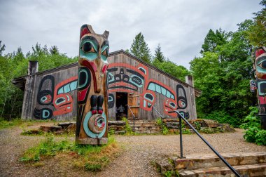 Saxman, Alaska - July 29, 2022: Tlinget totem poles, long house and traditional art.