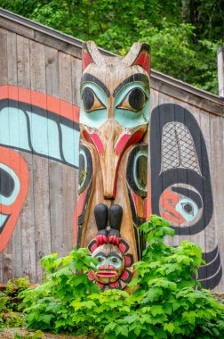 Saxman, Alaska - July 29, 2022: Tlinget totem poles, long house and traditional art.