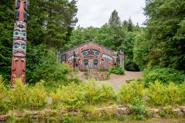 Saxman, Alaska - July 29, 2022: Tlinget totem poles, long house and traditional art.