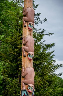 Saxman, Alaska - July 29, 2022: Tlinget totem poles, long house and traditional art.