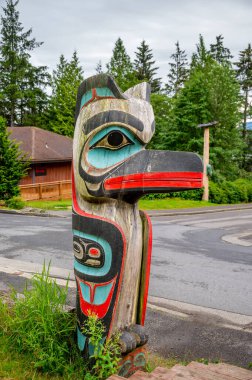 Saxman, Alaska - July 29, 2022: Tlinget totem poles, long house and traditional art.